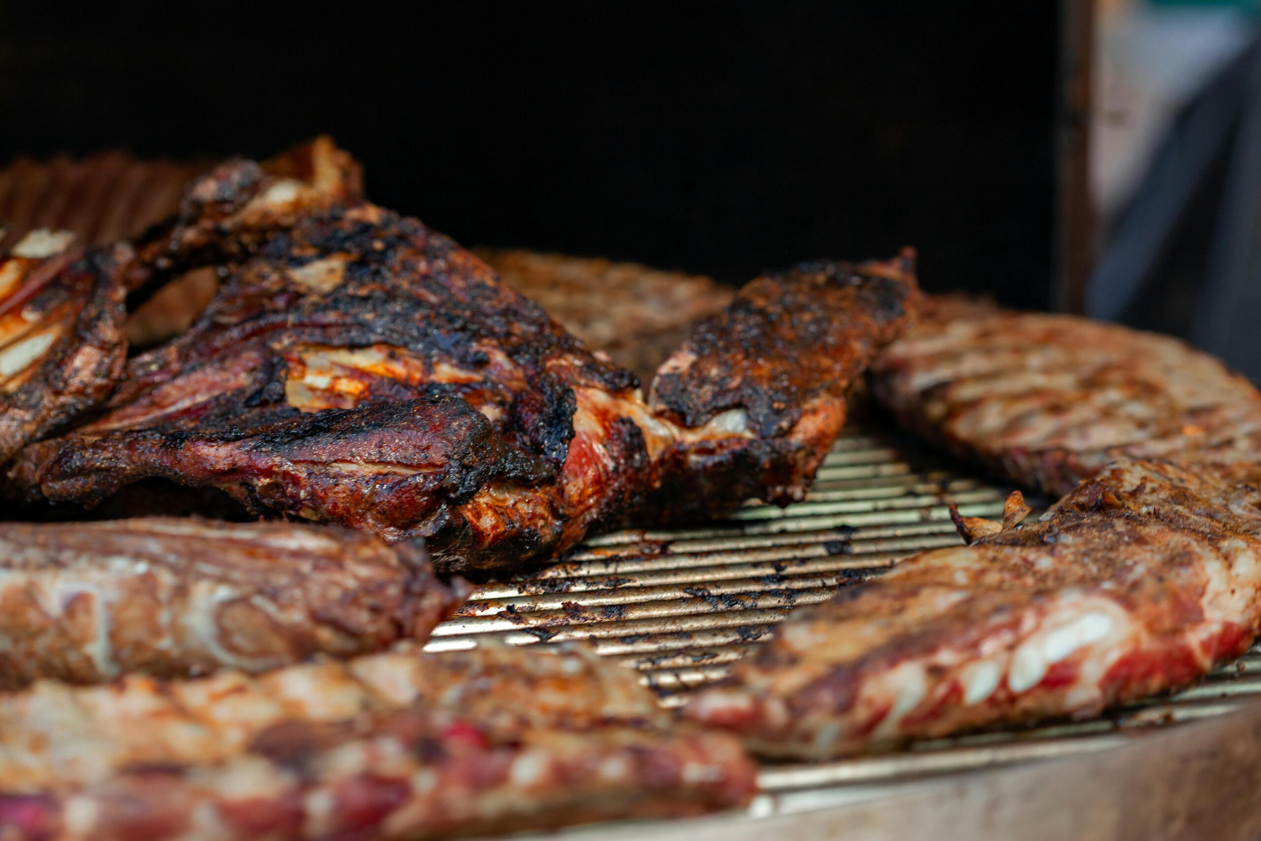 Juicy grilled meat seasoned and charred to perfection on a barbecue grill.